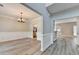 Elegant dining room featuring wainscoting, modern light fixture, and stainless steel refrigerator at 2035 Lena Carter Rd, Buford, GA 30519