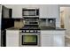 Kitchen boasts stainless steel appliances, granite countertops, and ample cabinet space at 2035 Lena Carter Rd, Buford, GA 30519