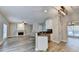 Open-concept kitchen with breakfast bar overlooking the living area, featuring a cozy fireplace and ample natural light at 2035 Lena Carter Rd, Buford, GA 30519