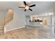 Open-concept living space featuring hardwood floors, a ceiling fan, and stairs to the upper level at 2035 Lena Carter Rd, Buford, GA 30519