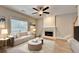 The living room features a ceiling fan, fireplace, and light-colored hardwood floors at 2035 Lena Carter Rd, Buford, GA 30519