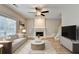 The living room features a ceiling fan, fireplace, and light-colored hardwood floors at 2035 Lena Carter Rd, Buford, GA 30519