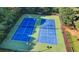 Aerial view of community tennis courts at Hampton Park, perfect for recreational play amid a scenic wooded setting at 2035 Lena Carter Rd, Buford, GA 30519