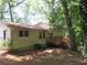 View of the home's backyard and deck, surrounded by mature trees at 5512 Arrowhead Dr, Acworth, GA 30102