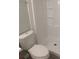 Bright bathroom features a toilet and a shower with white wall panels and built-in shelves at 5512 Arrowhead Dr, Acworth, GA 30102