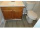 Bathroom with a traditional vanity and toilet, paired with modern vinyl flooring at 5512 Arrowhead Dr, Acworth, GA 30102