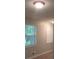 Bedroom featuring neutral paint, two windows with blinds and modern flooring at 5512 Arrowhead Dr, Acworth, GA 30102