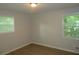 This bedroom features neutral paint, two windows, and modern flooring at 5512 Arrowhead Dr, Acworth, GA 30102