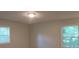 Bright bedroom with neutral walls and two large windows at 5512 Arrowhead Dr, Acworth, GA 30102