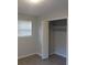 Bedroom featuring modern flooring, a window, and a closet with bifold doors at 5512 Arrowhead Dr, Acworth, GA 30102
