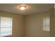 Bright bedroom with neutral paint, featuring two windows, and a center ceiling light at 5512 Arrowhead Dr, Acworth, GA 30102