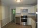 Modern kitchen features granite countertops, stainless steel appliances, and white cabinets at 5512 Arrowhead Dr, Acworth, GA 30102