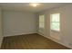 Bright living room features wood-look floors and sun-filled windows at 5512 Arrowhead Dr, Acworth, GA 30102