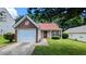 Charming single-story home featuring a well-maintained lawn and attached one car garage at 6572 Chestnut Oaks Rdg, Lithonia, GA 30038