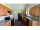 Well-equipped kitchen featuring wooden cabinets and modern black appliances at 6572 Chestnut Oaks Rdg, Lithonia, GA 30038