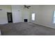 Bright living room featuring neutral walls, carpeting, and a cozy fireplace at 6572 Chestnut Oaks Rdg, Lithonia, GA 30038