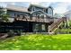 Large wooden deck overlooking a lush backyard with walkout basement at 735 Jamie Ne Way, Woodstock, GA 30188