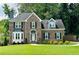 Charming brick home with lush lawn and well-maintained landscaping at 735 Jamie Ne Way, Woodstock, GA 30188