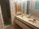 Bathroom with dual sinks, shower, and floral wallpaper at 975 Willeo Rd, Roswell, GA 30075