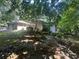 View of house exterior with lush foliage surrounding the home and a detached garage at 975 Willeo Rd, Roswell, GA 30075