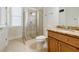 Bathroom features glass enclosed shower, tile floors, and vanity with wooden cabinets and granite countertop at 1505 Walker Ave, College Park, GA 30337