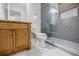 Bathroom with gray tiled walk-in shower, wooden vanity, and modern fixtures at 1505 Walker Ave, College Park, GA 30337