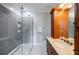 Bathroom featuring a glass shower, vanity, and wooden cabinets at 1505 Walker Ave, College Park, GA 30337