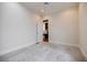 Spacious bedroom offers neutral walls, plush carpet, ceiling fan, and an open door to reveal built-in shelves at 1505 Walker Ave, College Park, GA 30337