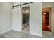 Bedroom features a barn door to the bathroom and an open doorway, creating a seamless transition between spaces at 1505 Walker Ave, College Park, GA 30337