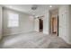 Bright bedroom with plush carpet, sliding barn door to the bathroom, and a window providing natural light and charm at 1505 Walker Ave, College Park, GA 30337