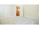 Bright bedroom featuring plush carpet, neutral walls, and a doorway to an adjacent hallway at 1505 Walker Ave, College Park, GA 30337