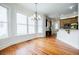 Inviting dining area with large windows and elegant chandelier, flowing to kitchen at 1505 Walker Ave, College Park, GA 30337