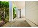 Stone pathway leading to a covered entryway with white pillars and lush greenery at 1505 Walker Ave, College Park, GA 30337
