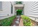 Inviting entrance with stone pathway surrounded by manicured landscaping and covered walkway at 1505 Walker Ave, College Park, GA 30337