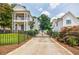 Stunning two-story home featuring a manicured lawn and an elegant gated driveway at 1505 Walker Ave, College Park, GA 30337