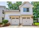 Two-car garage with carriage doors and craftsman style, creating curb appeal and practical parking solutions at 1505 Walker Ave, College Park, GA 30337