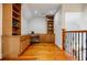 Hallway with built-in wooden shelves, desk area, and hardwood floors, providing a functional and stylish workspace at 1505 Walker Ave, College Park, GA 30337