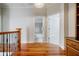 Hallway with hardwood floors, an open view of the bathroom, and a hallway to the bedrooms at 1505 Walker Ave, College Park, GA 30337