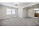 The bright living room offers soft carpeting, recessed lighting, and multiple windows at 1505 Walker Ave, College Park, GA 30337
