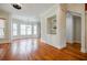Spacious living room with hardwood flooring, built in shelves and large windows at 1505 Walker Ave, College Park, GA 30337