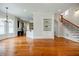 Open-concept living room featuring hardwood floors, built-in shelves, and staircase at 1505 Walker Ave, College Park, GA 30337