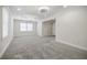 Bright living room offers soft carpeting, recessed lighting, and multiple windows at 1505 Walker Ave, College Park, GA 30337