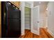An open pantry door showing well-organized shelving next to a refrigerator in a bright kitchen at 1505 Walker Ave, College Park, GA 30337