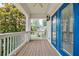 Charming covered porch boasting blue doors, white railings, and a wooden deck perfect for outdoor relaxation at 1505 Walker Ave, College Park, GA 30337