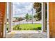Covered porch with stone flooring shows an open view to a green lawn and trees, offering an inviting outdoor space at 1505 Walker Ave, College Park, GA 30337