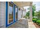 Charming porch features double doors, stone flooring, and an inviting outdoor space, perfect for relaxing and enjoying the view at 1505 Walker Ave, College Park, GA 30337