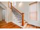 Elegant staircase with wooden treads, iron railings, and natural light creates a warm and inviting atmosphere in the home at 1505 Walker Ave, College Park, GA 30337