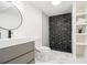 Modern bathroom featuring stylish vanity and open shower with black and white mosaic tiles at 3388 Hyland Dr, Decatur, GA 30032