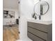 Modern bathroom featuring stylish vanity with a round mirror and black hardware accents at 3388 Hyland Dr, Decatur, GA 30032