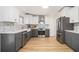 Updated eat-in kitchen with stainless steel appliances, stylish gray and white cabinetry and light wood floors at 3388 Hyland Dr, Decatur, GA 30032